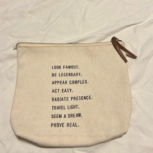 Canvas makeup bag with inspirational quotes. Zip closure with leather pull